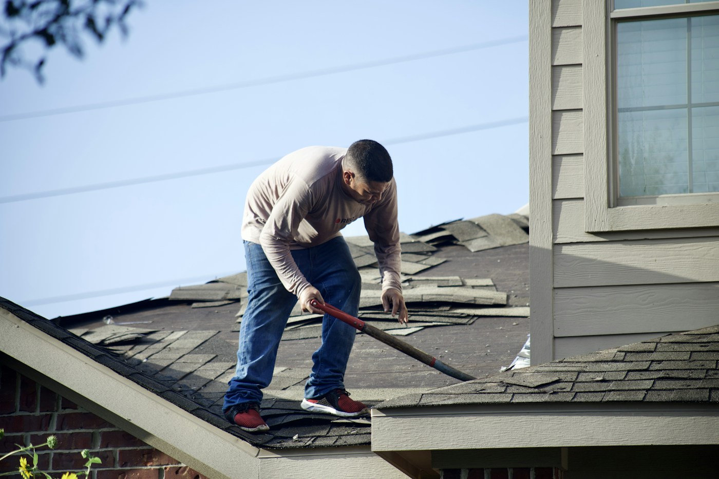 Roofing professional working on a residential roof
